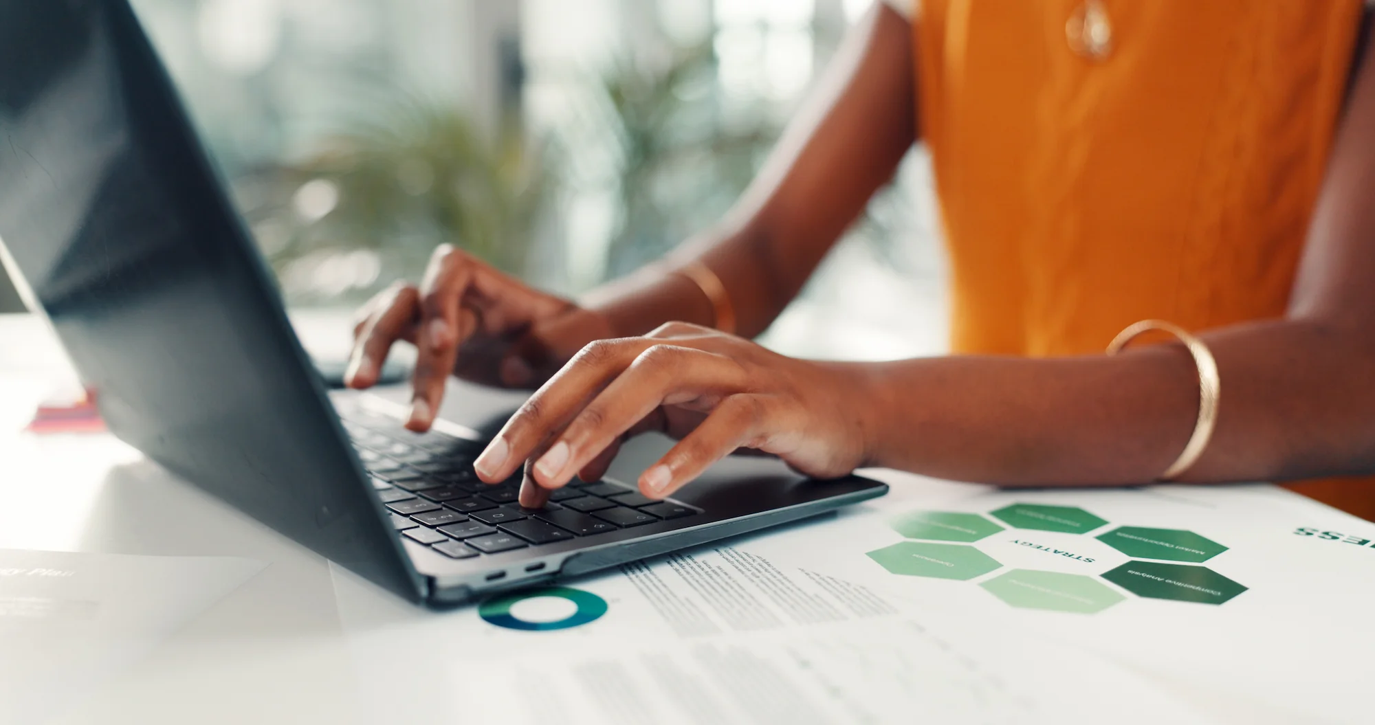 Person using a laptop while reviewing business information and settings